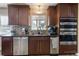 Modern kitchen with stainless steel appliances, wooden cabinets, and tile backsplash at 760 Deframe St, Golden, CO 80401