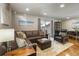 Comfortable living room with a leather sectional, a plush ottoman, an accent chair, and hardwood flooring at 760 Deframe St, Golden, CO 80401
