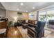 Cozy living room with a comfortable brown sectional, recliner, hardwood floors, and access to the backyard patio at 760 Deframe St, Golden, CO 80401