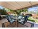 Outdoor patio features a covered dining area and additional seating for relaxing and enjoying the backyard views at 760 Deframe St, Golden, CO 80401