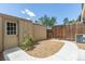 Fenced backyard with door to shed, wood trim and mulched ground at 8780 E Yale Ave, Denver, CO 80231