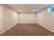 Finished basement offering a spacious area with neutral carpet, lighting, and egress window for natural light at 8780 E Yale Ave, Denver, CO 80231
