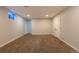 Finished basement showcasing carpet flooring, neutral walls, recessed lighting, and possible storage access at 8780 E Yale Ave, Denver, CO 80231