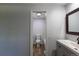 Bathroom featuring a toilet, tub with a tiled backsplash, mirror, and vanity offering comfort and convenience at 8780 E Yale Ave, Denver, CO 80231