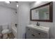 Renovated bathroom features a modern vanity, large mirror, and luxurious tiled shower area for a spa-like feel at 8780 E Yale Ave, Denver, CO 80231
