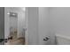 Bathroom with hardwood floors, white walls and white toilet at 8780 E Yale Ave, Denver, CO 80231