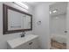 Bathroom featuring granite countertop, dark bronze fixtures, and hardwood flooring at 8780 E Yale Ave, Denver, CO 80231