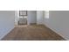 Bedroom view into bathroom, features an open-concept design with natural light and a carpeted floor for comfort at 8780 E Yale Ave, Denver, CO 80231