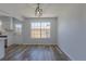 Open-concept dining area with wood-look flooring, natural light, and access to the kitchen at 8780 E Yale Ave, Denver, CO 80231