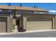 View of the tan detached garage in front of the condo unit at 8780 E Yale Ave, Denver, CO 80231
