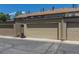Tan detached garage on cracked pavement under a bright blue sky at 8780 E Yale Ave, Denver, CO 80231