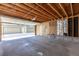 Spacious detached garage with concrete floor and exposed ceiling beams at 8780 E Yale Ave, Denver, CO 80231