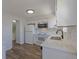 Bright, updated kitchen with white cabinets, quartz countertops, and stainless steel appliances, designed for efficiency at 8780 E Yale Ave, Denver, CO 80231