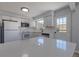 Modern kitchen with white cabinetry, stainless steel appliances, and a center island, perfect for cooking at 8780 E Yale Ave, Denver, CO 80231