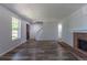 Open-concept living room with wood floors, neutral paint, a fireplace, and access to a staircase at 8780 E Yale Ave, Denver, CO 80231