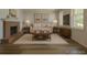 Inviting living room features a cozy fireplace, neutral decor, and ample space for relaxation and entertainment at 8780 E Yale Ave, Denver, CO 80231