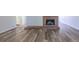 Living room with hard surface floors and a traditional fireplace with brick hearth and surround at 8780 E Yale Ave, Denver, CO 80231