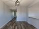 Open-concept living space with wood floors and neutral paint and view into an adjacent room at 8780 E Yale Ave, Denver, CO 80231