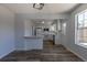 Open-concept living space with wood floors, and an eat-in bar that looks into the kitchen at 8780 E Yale Ave, Denver, CO 80231