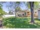 Backyard view showcasing a covered porch and mature trees at 359 S 25Th Ave, Brighton, CO 80601