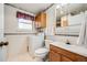 Functional bathroom with classic fixtures, tiled walls, and convenient washer and toilet combo at 359 S 25Th Ave, Brighton, CO 80601