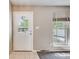 Bright foyer featuring tile flooring, a window with blinds, and a white front door with decorative glass at 359 S 25Th Ave, Brighton, CO 80601