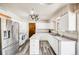 Bright kitchen with stainless steel appliances, white cabinets, an island, and wood-look floors at 359 S 25Th Ave, Brighton, CO 80601