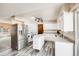 Bright kitchen with stainless steel appliances, white cabinets, an island, and wood-look floors at 359 S 25Th Ave, Brighton, CO 80601