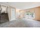 Bright and airy living room with plush carpeting, neutral walls, and a staircase leading to the upper level at 359 S 25Th Ave, Brighton, CO 80601