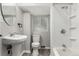 Compact bathroom with a pedestal sink, toilet, and tiled shower/tub combination at 725 Knox Ct, Denver, CO 80204