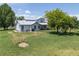 Aerial view of the property and home showcasing the generous yard and the home's exterior at 5602 County Road 15, Fort Lupton, CO 80621