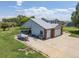 Aerial shot showcasing the home, oversized garage, and extended driveway, along with the expansive lawn at 5602 County Road 15, Fort Lupton, CO 80621