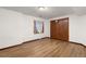 Basement includes vinyl flooring, a window with sheer white curtains, and closet with wood paneled doors at 5602 County Road 15, Fort Lupton, CO 80621