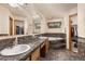 Bathroom features a marble countertop and tub, alongside a walk-in closet for storage at 5602 County Road 15, Fort Lupton, CO 80621