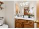 Well-lit half bathroom with vanity, decorative mirror, and stylish accents at 5602 County Road 15, Fort Lupton, CO 80621
