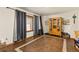 Bright dining room featuring unique flooring, large window, and a wooden display cabinet at 5602 County Road 15, Fort Lupton, CO 80621