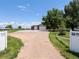 A home with a three-car garage, large driveway, well-maintained lawn, and a privacy fence at 5602 County Road 15, Fort Lupton, CO 80621
