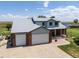 Birds eye view of the house featuring a 3-car garage, and front patio, with a spacious driveway at 5602 County Road 15, Fort Lupton, CO 80621