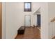 Inviting foyer features hardwood floors, high ceilings, a bench, and a modern entry door at 5602 County Road 15, Fort Lupton, CO 80621
