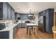 Modern kitchen featuring gray cabinets, stainless steel appliances, and a central island with seating at 5602 County Road 15, Fort Lupton, CO 80621