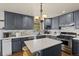 Beautiful kitchen featuring gray cabinetry, a center island, and stainless steel appliances at 5602 County Road 15, Fort Lupton, CO 80621