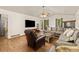 Bright and airy living room with hardwood floors, a comfortable sectional, and a ceiling fan at 5602 County Road 15, Fort Lupton, CO 80621