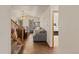 A spacious living room featuring hardwood floors, vaulted ceiling, and a comfortable grey sectional at 5602 County Road 15, Fort Lupton, CO 80621