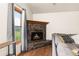 Cozy living room featuring a fireplace with marble surround and natural light at 5602 County Road 15, Fort Lupton, CO 80621