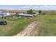 Aerial view of the property, revealing multiple sheds and outbuildings in a rural setting at 5602 County Road 15, Fort Lupton, CO 80621