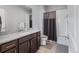 Bathroom featuring a vanity with granite countertop and a shower with a gray shower curtain at 5110 E 64 Ave, Commerce City, CO 80022