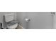 Toilet in the bathroom with gray walls and a roll of toilet paper on the wall at 5110 E 64 Ave, Commerce City, CO 80022