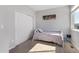 Bedroom with a twin bed, window, closet, and carpet flooring at 5110 E 64 Ave, Commerce City, CO 80022