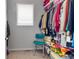 Walk-in closet with ample storage space and a variety of colorful clothing at 5110 E 64 Ave, Commerce City, CO 80022