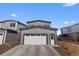 Contemporary two-story home with two-car attached garage, complemented by an easy to maintain front yard at 5110 E 64Th Ave, Commerce City, CO 80022